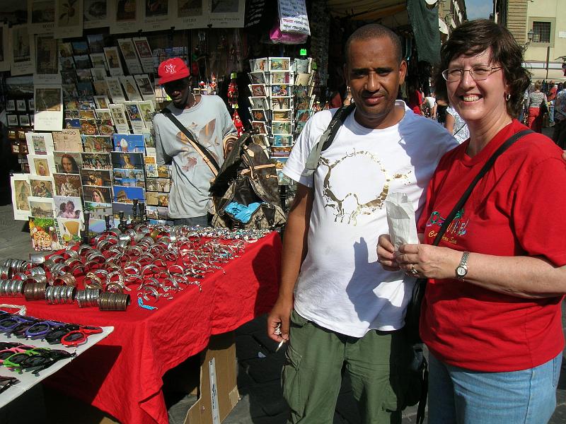 DSCN1577.JPG - A tourist making a purchase from a street vendor in the Lorenzo shopping district